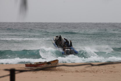 Early morning surf launch action as divers head out at Praia do Tofo